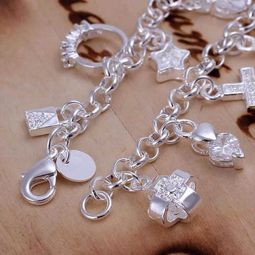 "Close-up of 925 silver hanging charm bracelet"